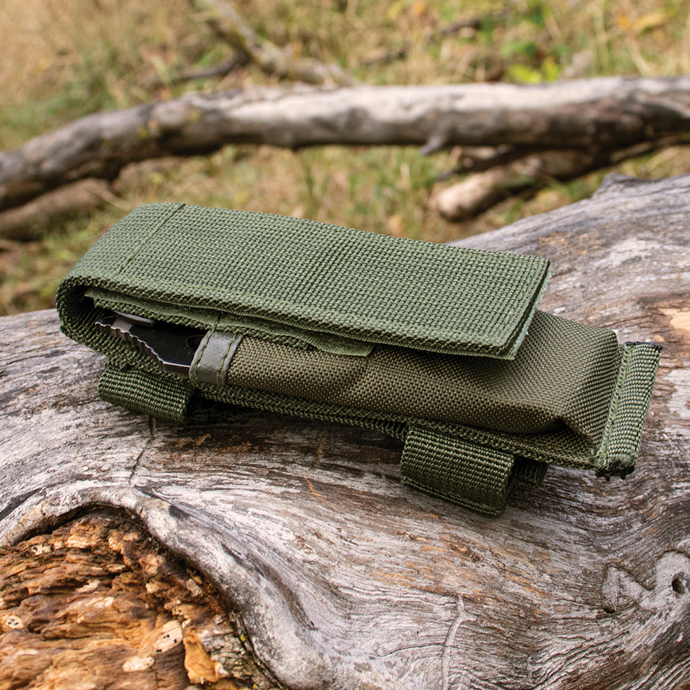 Modular Knife Sheath with a knife inside on top of a fallen tree.