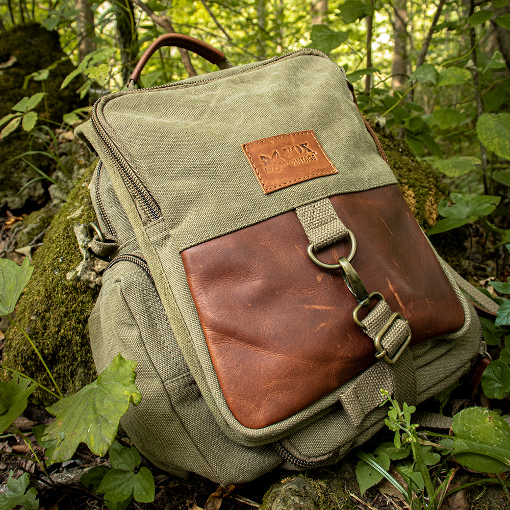 Valencian Daily Organizer laying on a mossy rock in the woods.