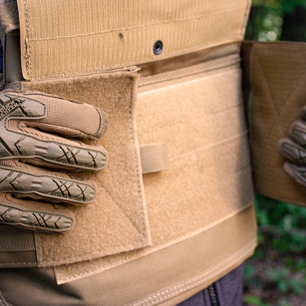 Man wearing Vital Plate Carrier Vest adjusting front flaps.