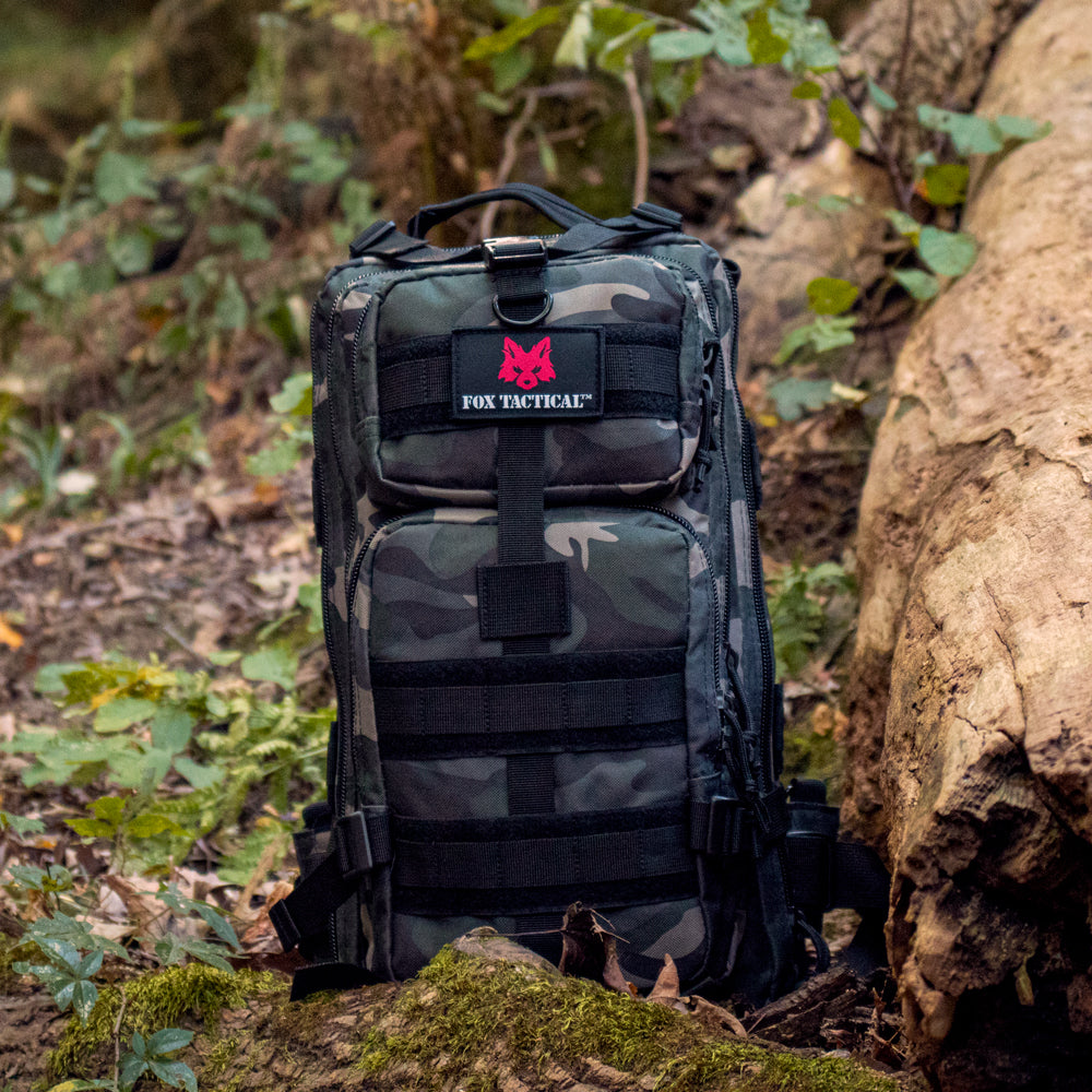 Medium Transport Pack on a mossy log in a forest.