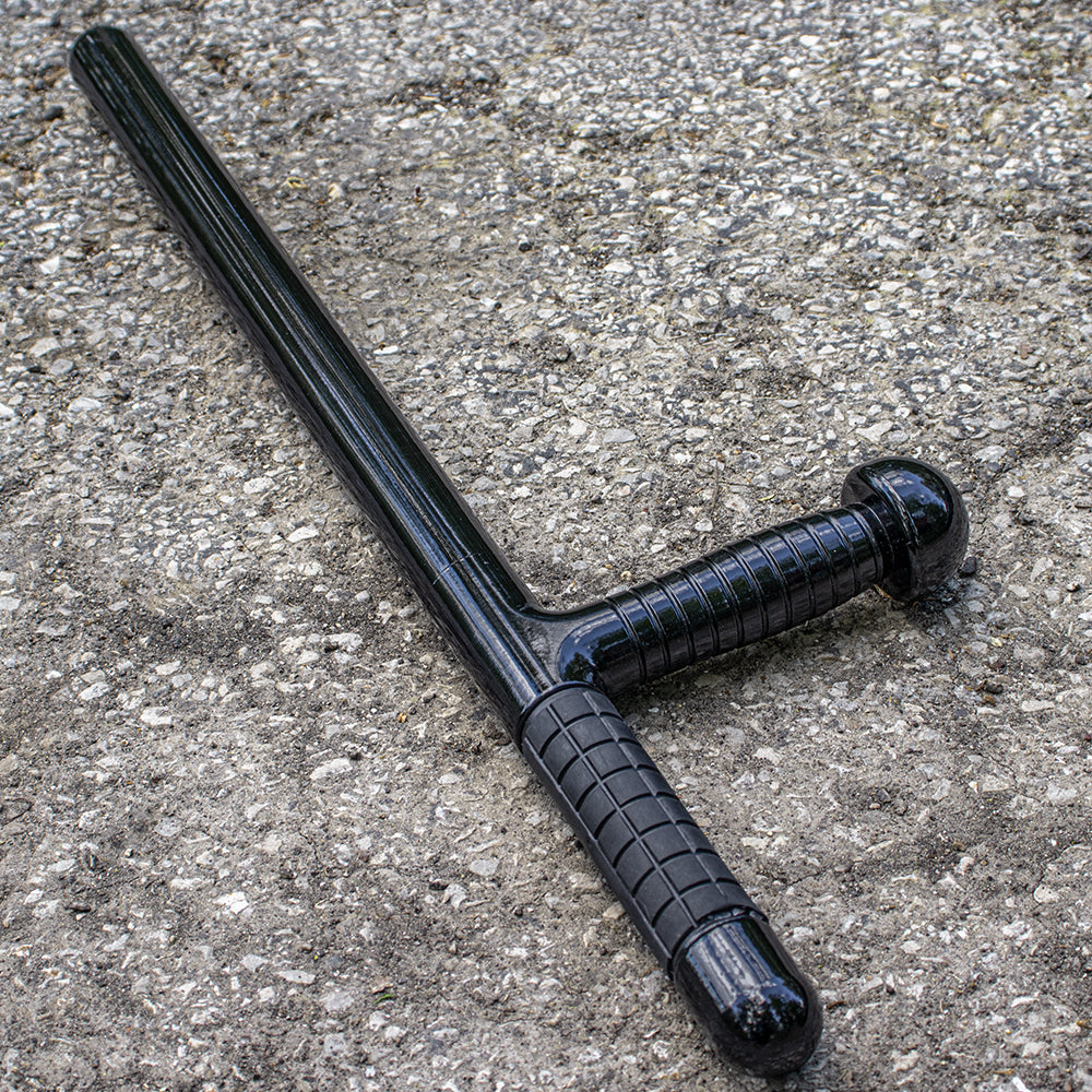 Fiberglass Baton with Side Handle on a grey gravel pavement.