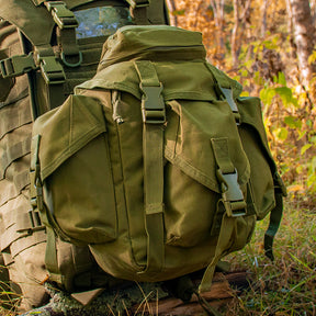 Recon Butt Pack on another tactical pack sitting on the ground in the woods during autumn.