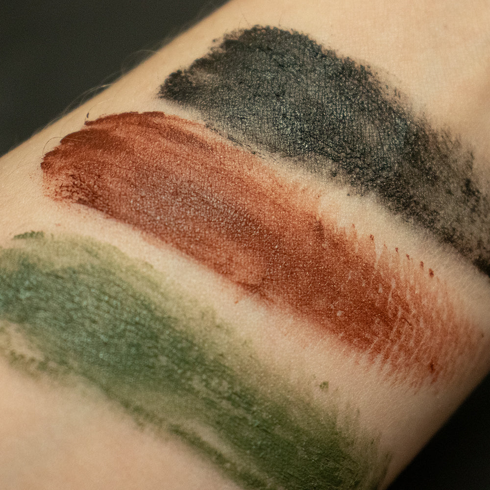 Swatch of all three colors in GI Style Face Paint Compact on light-toned  skin.