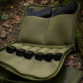 Dual Tactical Pistol Case open showing two pistols and mags in the woods.