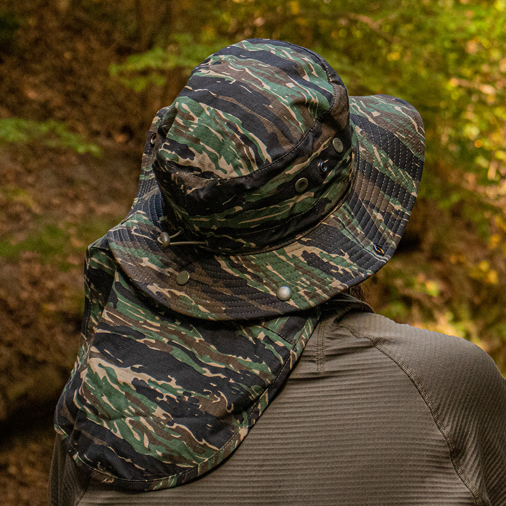 Man wearing an Advanced Hot-Weather Boonie Hat outside in the woods.