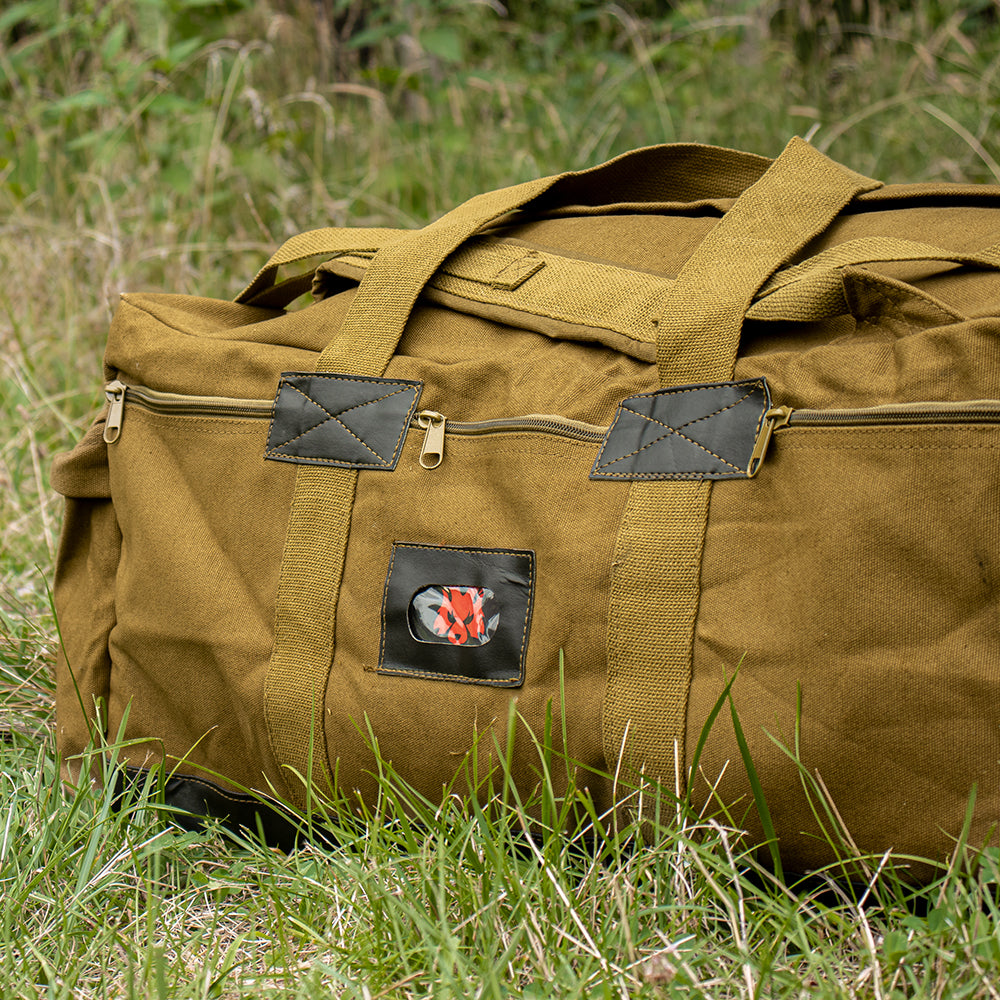 IDF Tactical Bag laying in a grassy field.