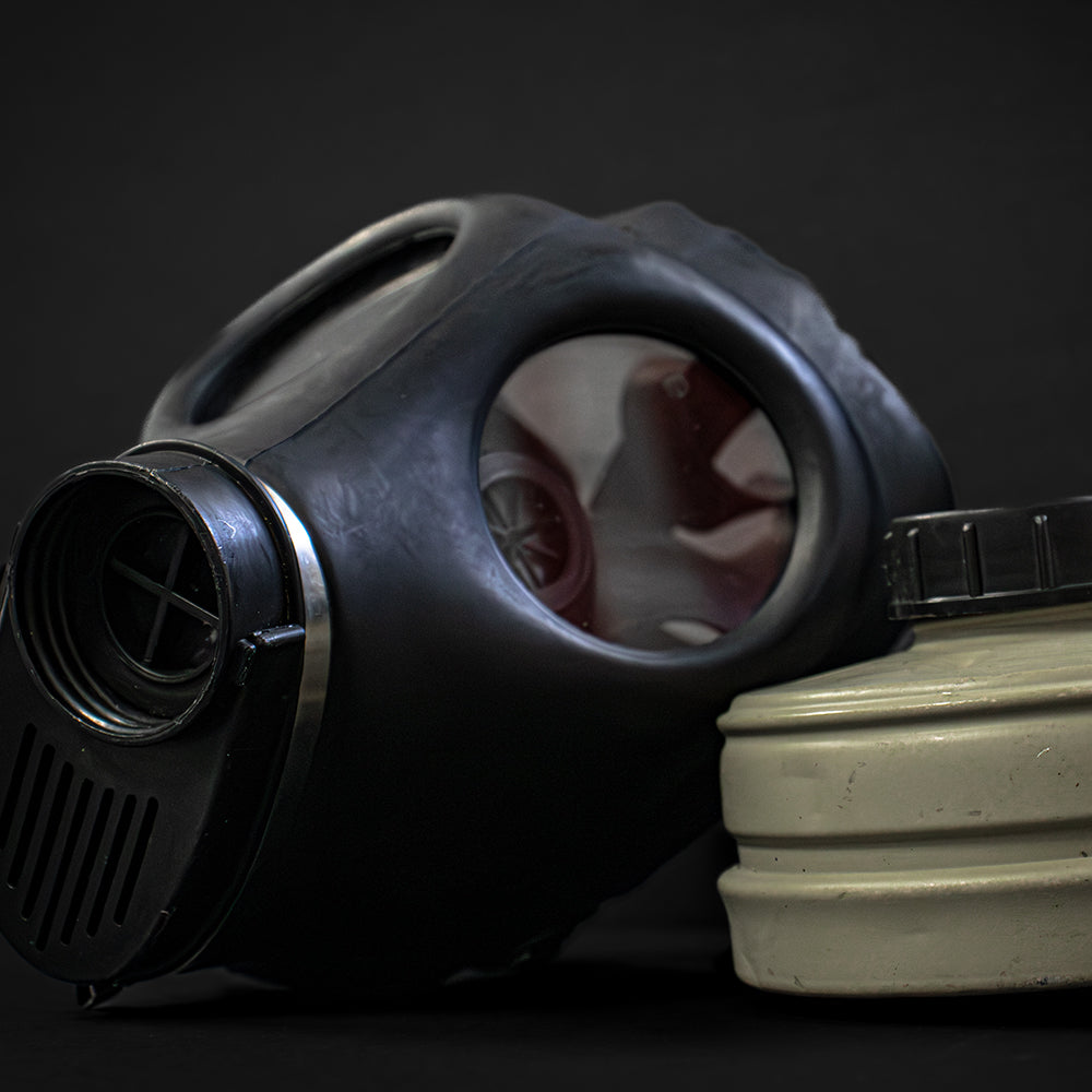 Civilian Israeli Army Gas Mask with Filter on a black background.