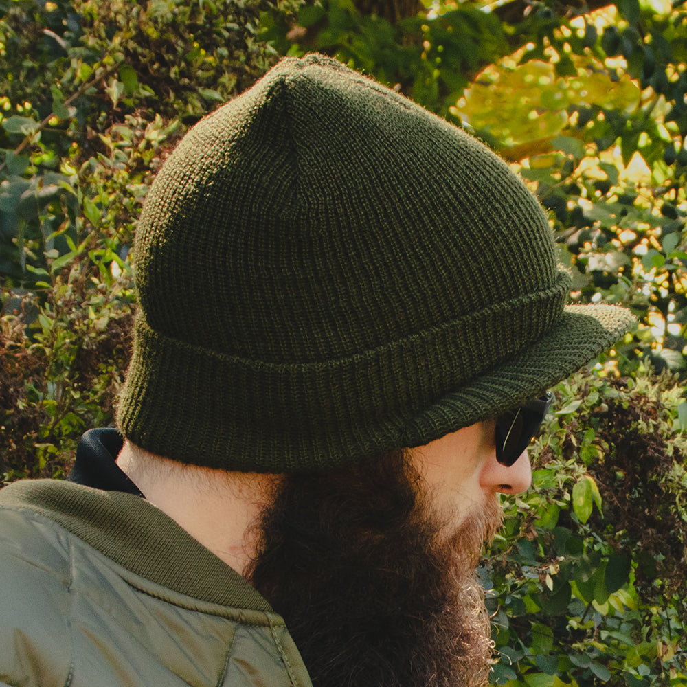 Gi Wool Jeep Cap being worn on a man outside in the woods on a sunny fall day. 