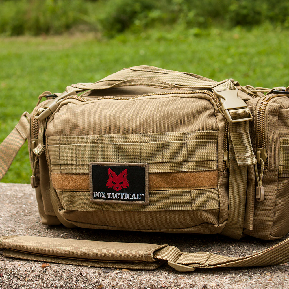 Jumbo Modular Deployment Bag on a parking block in front of a grassy field.