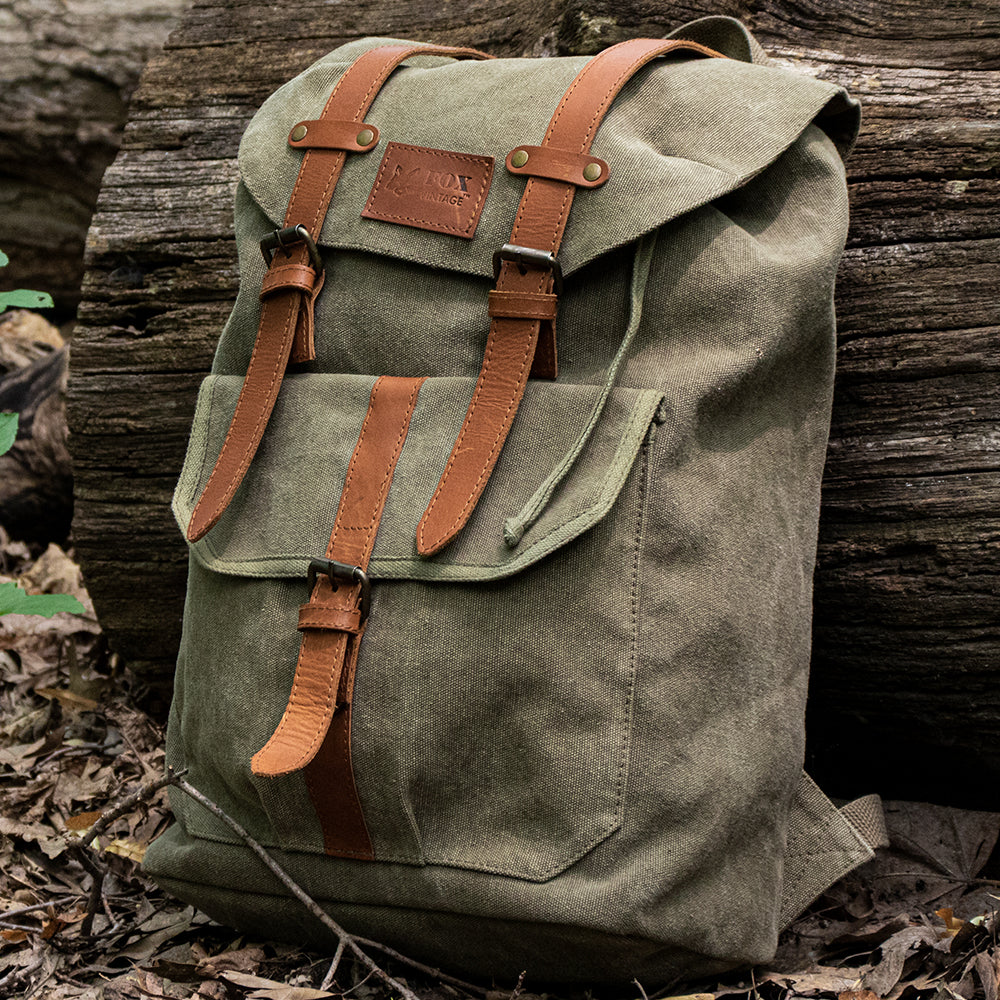 Retro Madridian Rucksack laying against a log.