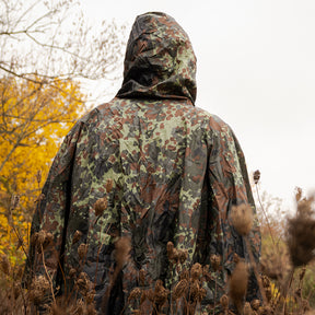 Person wearing a Ripstop Poncho in an autumn-colored field.