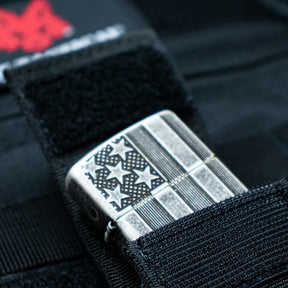 Close-up of a Zippo® Lighter inside an open Zippo® Pouch on a tactical pack.