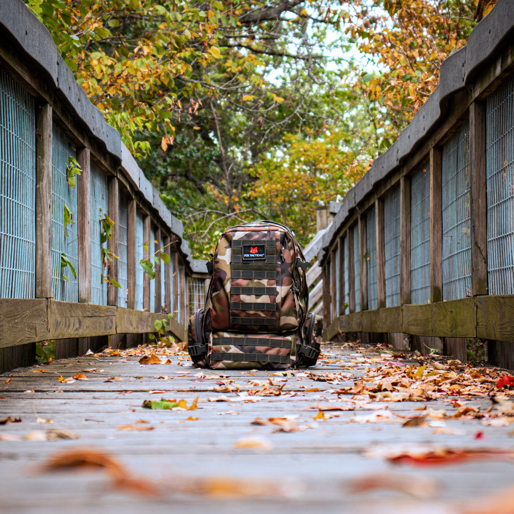 Advanced 2-Day Combat Pack in the middle of a wooden bridge surrounded by fall foliage. 