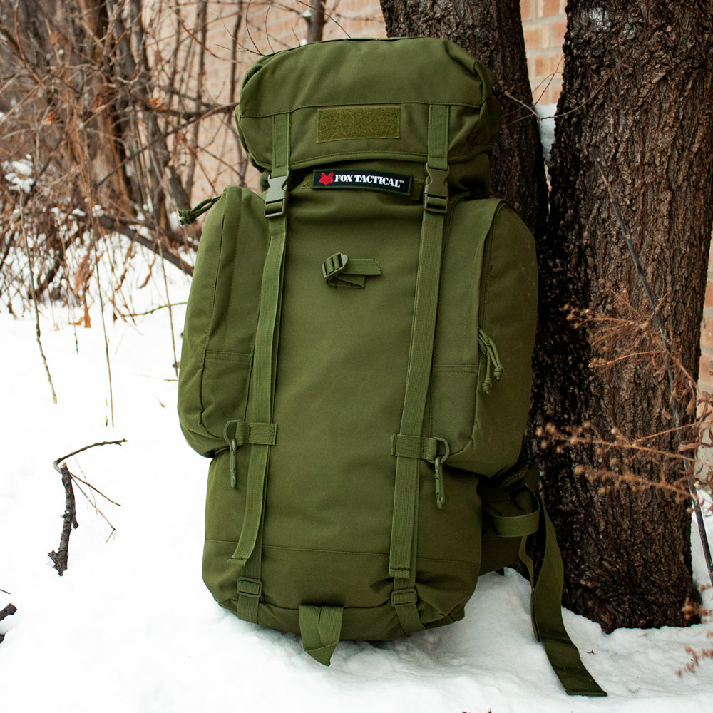 Rio Grande Pack - 75 Liter lying against a tree in the snow.
