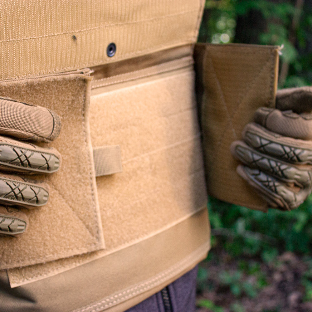 Closeup of Big and Tall Vital Plate Carrier Vest on a person adjusting the front flaps.