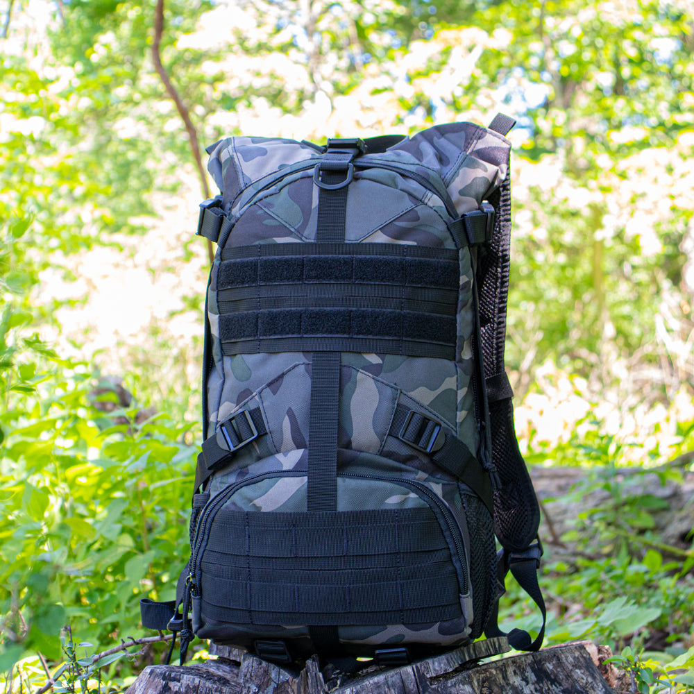 Elite Excursionary Hydration Pack sitting on a stump with bright foliage in the background.