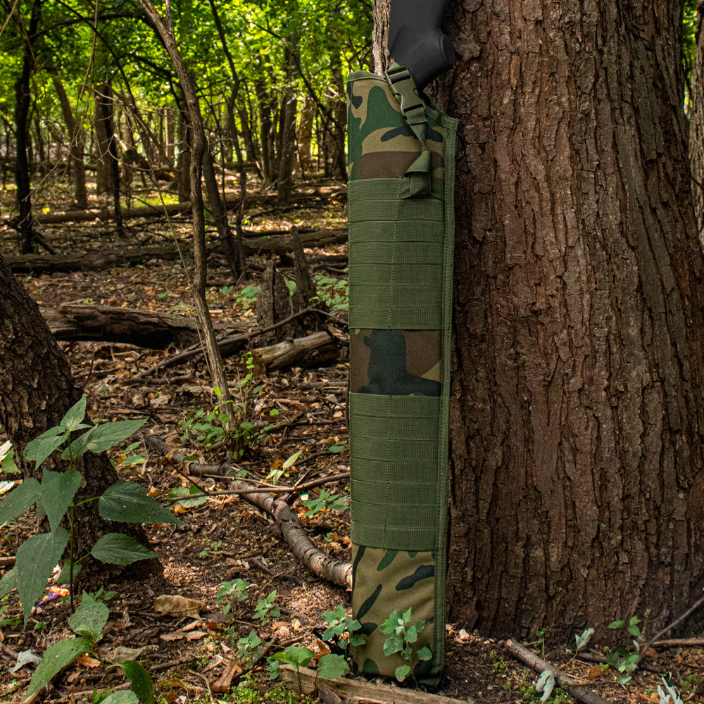 Tactical Shotgun Scabbard propped up against a tree in the woods.